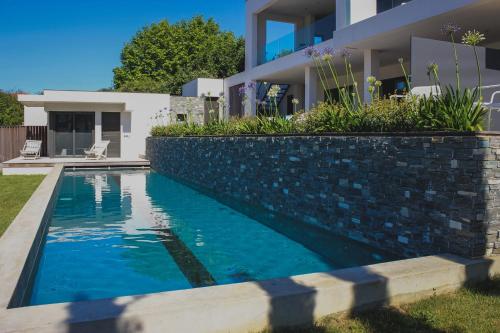 a swimming pool in front of a house at LAKEVIEW-KEYWEEK-villa Biarritz - Swimming pool in Biarritz