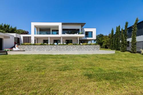 a house with a lawn in front of it at LAKEVIEW-KEYWEEK-villa Biarritz - Swimming pool in Biarritz