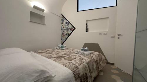 a bedroom with a bed with a quilt on it at La mia casetta al mare in Minori