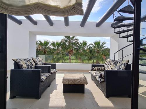 a living room with two chairs and a table at Penthouse Golf lujo, Perla Sol 1 in Vera