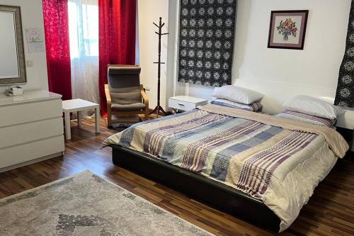 a bedroom with a bed and a chair in it at 3 bedroom apt excellent location near to malls in Cairo