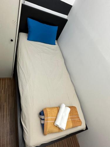 a bed in a room with two towels on it at Fancy Partition Room Near Mashreq Metro / SZ Road in Dubai