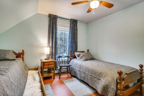 a bedroom with two beds and a window at Charming Wilton Vacation Rental with Fire Pit in Wilton