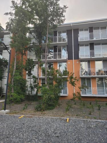 an apartment building with trees in front of it at Departamento nuevo pucon in Pucón