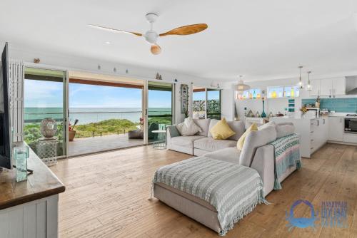 a living room with a couch and a kitchen at Luxury Sunset & Surf in Halls Head in Wannanup