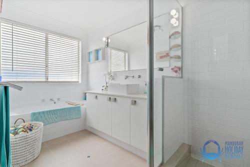 a white bathroom with a sink and a shower at Luxury Sunset & Surf in Halls Head in Wannanup