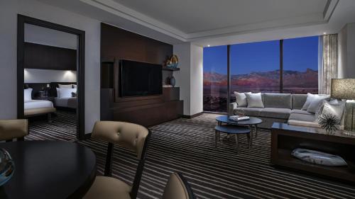 a living room with a couch and a room with a view at Red Rock Casino Resort & Spa in Las Vegas