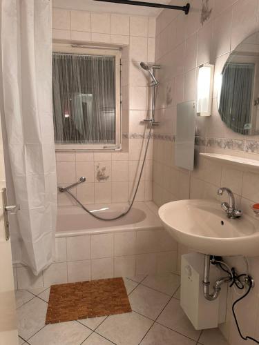 a bathroom with a shower and a sink and a tub at Premium Handwerker Zimmer in Balingen