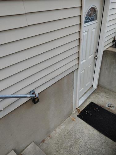 a white door with a handle next to a doorstep at Guest house in a quiet peaceful area. in Mariners Harbor