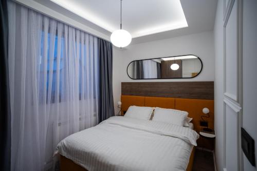 En eller flere senge i et værelse på Apartman G1