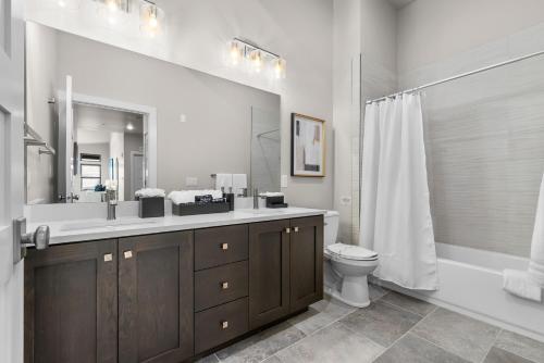 a bathroom with a sink and a toilet and a mirror at Luxury Stays Club 301, Lovely 3br condo, New Deer Valley 1 min, Park City 10 min in Cranmer