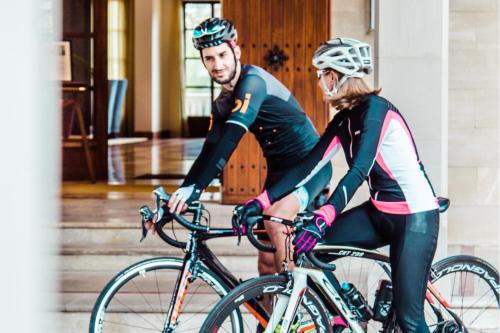 a man and a woman riding on bikes at Castillo Hotel Son Vida, a Luxury Collection Hotel, Mallorca in Palma de Mallorca