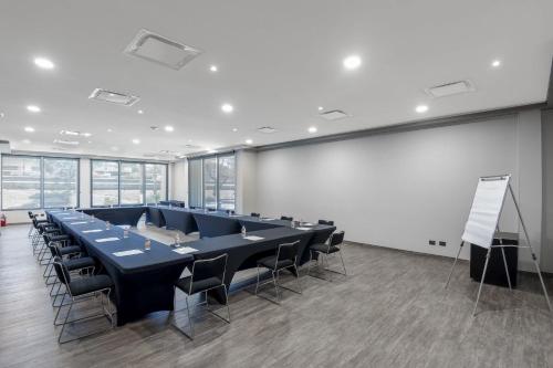 a conference room with a long table and chairs at City Express by Marriott Torreon in Torreón