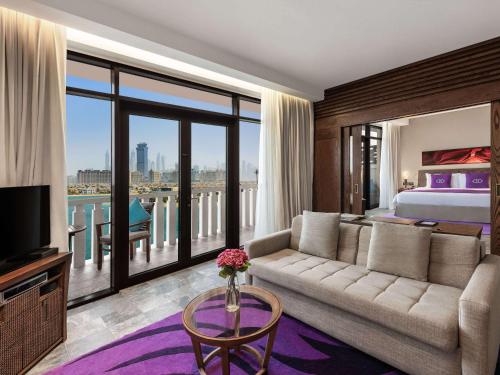 a living room with a couch and a bed at Sofitel Dubai The Palm Resort & Spa in Dubai