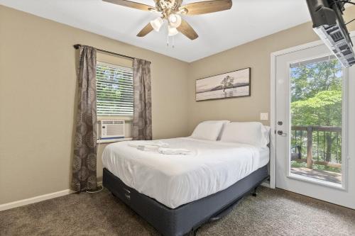 a bedroom with a bed and a window at 6bedrooms, ramp boat dock slips water toys, nice cove area in Linn Creek