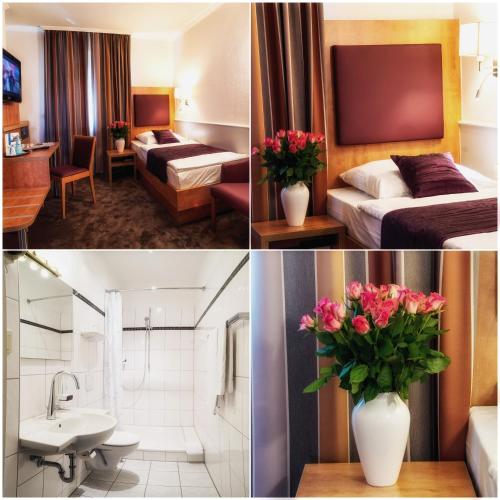 a hotel room with two beds and a vase of flowers at City Hotel Niederrad in Frankfurt