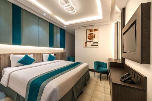 a hotel room with a bed and a television at Best Western Ajyad Makkah in Makkah