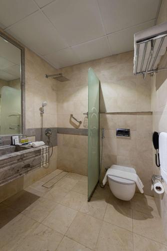 a bathroom with a toilet and a sink at Best Western Ajyad Makkah in Makkah