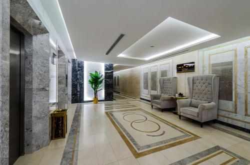 a lobby with two chairs and a rug on the floor at Best Western Ajyad Makkah in Makkah