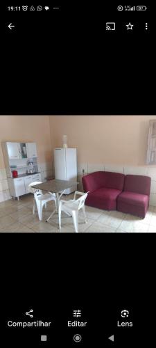 uma sala de estar com um sofá vermelho e uma mesa em Recanto Renascer (hostel e Pousada) em Rio Branco