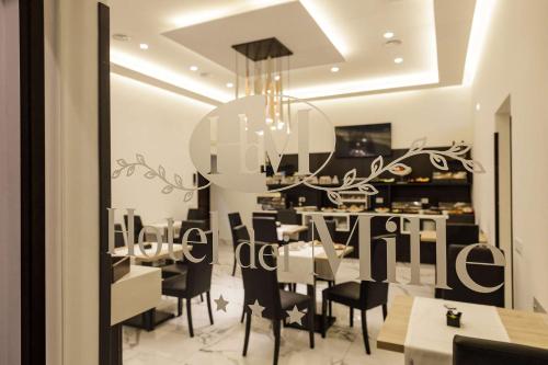 a dining room with a table and chairs and a chandelier at Best Western Hotel dei Mille in Naples