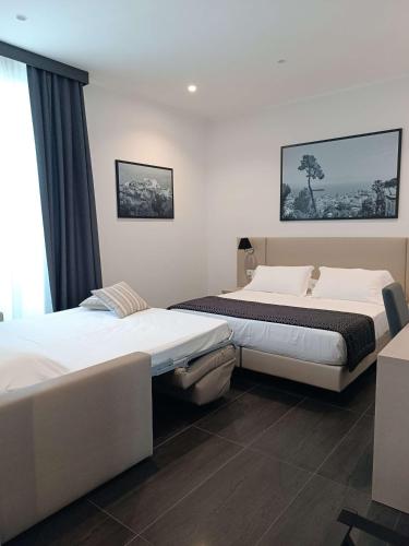 a bedroom with two beds and a window at Best Western Hotel dei Mille in Naples