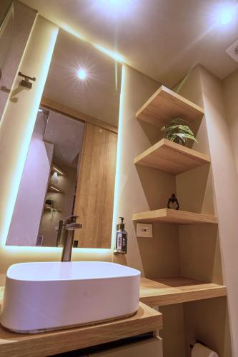 a bathroom with a white sink and a mirror at Acogedor apartamento con piscina en Bogotá in Bogotá
