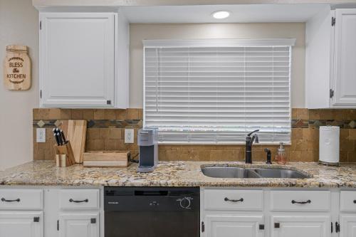 a kitchen with a sink and a window at Tranquil Paradise 4BR - 2 Miles To Tampa Bucs Stadium in Tampa
