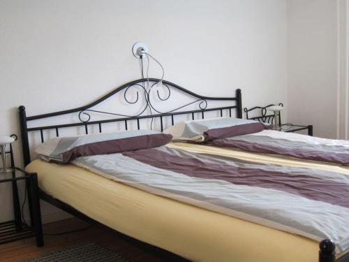 a bed with a metal headboard and pillows at Epple in Tübingen am Neckar in Tübingen