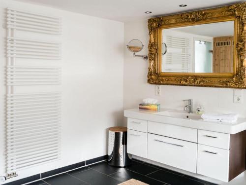 a bathroom with a sink and a mirror at Holiday home Huus Adele in Silberborn