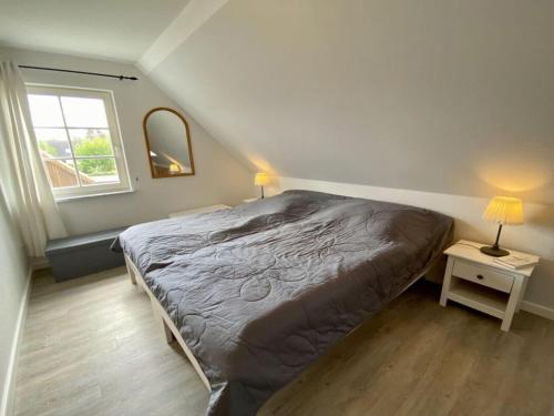 a bedroom with a large bed and a window at Holiday house house Finland in Beckerwitz