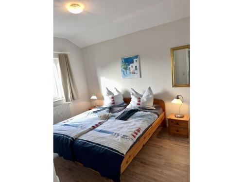 1 dormitorio con 1 cama con sábanas y almohadas blancas en 2 Zierow on the Baltic Sea, en Zierow