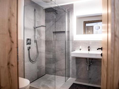 a bathroom with a shower and a sink at Green Residence XL in Wildschönau