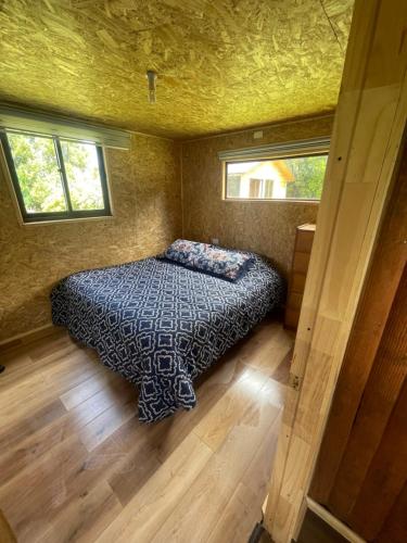 Säng eller sängar i ett rum på Cabaña con acceso a tinaja