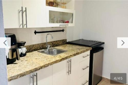 a kitchen with a sink and a counter top at Paradise Suite Cadaqués in Bayahibe