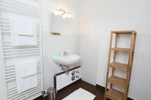 a bathroom with a sink and a mirror at Hotel Zur Linde in Hechthausen