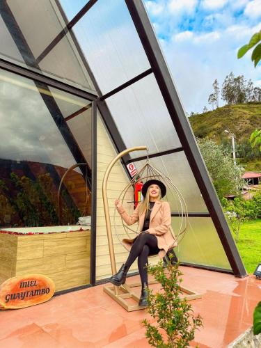 a woman sitting on a swing in a building at Destinos Exclusivos Patate in Patate