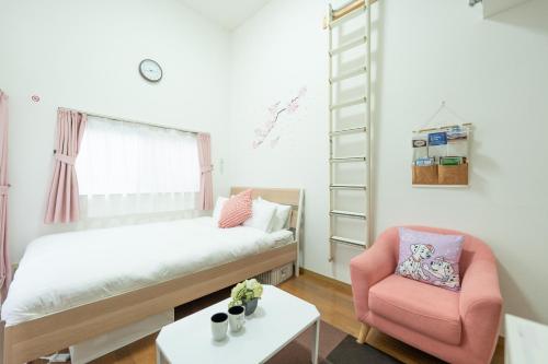 a small bedroom with a bed and a chair at ROOMs六本松 06 in Fukuoka
