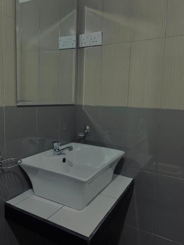 a bathroom with a white sink and a mirror at Ella South Star in Ella