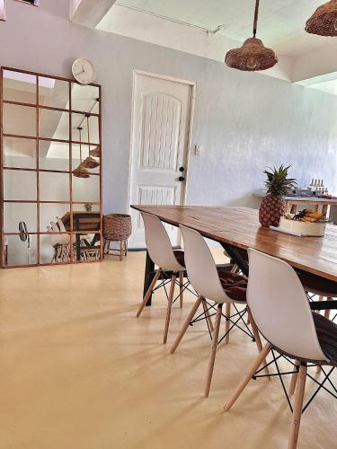 a dining room with a wooden table and chairs at Bahai ni Jhane in Calatagan