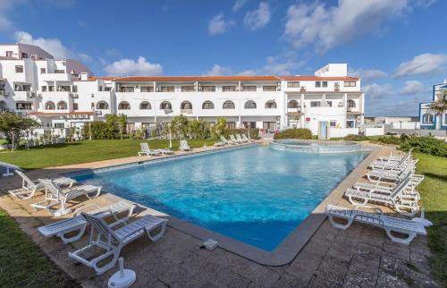 a swimming pool with lounge chairs and a resort at Beach & House''Villa Maria'' 5 min to Mareta Beach in Sagres