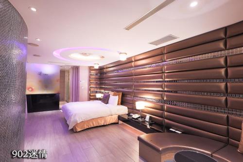 a bedroom with a bed and a television in it at Chimei Fashion Hotel in Zhongli