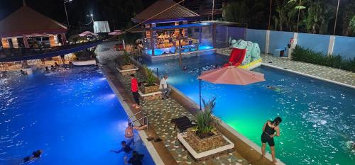 an overhead view of a swimming pool at night at PMG Islandscape Resort in Siquijor