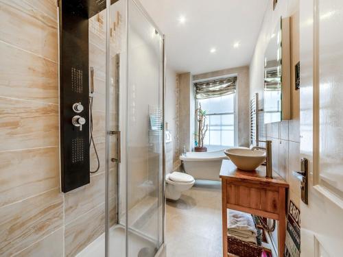 a bathroom with a shower and a toilet and a sink at Moonlight Apartment - Uk46023 in Durham
