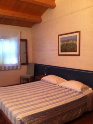 a bedroom with a bed in a room with a window at Agriturismo Accipicchia in Ancona