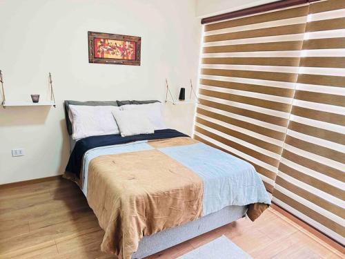 um quarto com uma cama e uma parede de madeira em EXCLUSIVO em Cochabamba