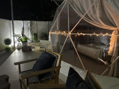 a bedroom with a bed with lights on it at Amaj Eco Lodge in Sámara