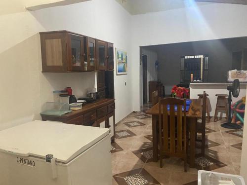 uma cozinha com um frigorífico e uma mesa em Casa Marudá em Marapanim
