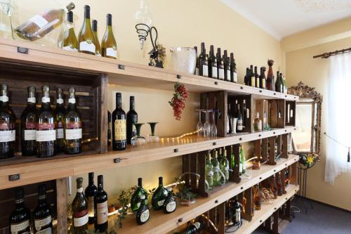 a room filled with lots of bottles of wine at Hotel Zur Linde in Hechthausen