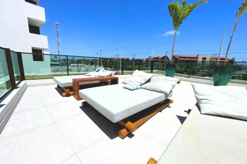two beds on the roof of a house at Studio de Luxo em Muro Alto - Makia Beach A209 in Porto De Galinhas